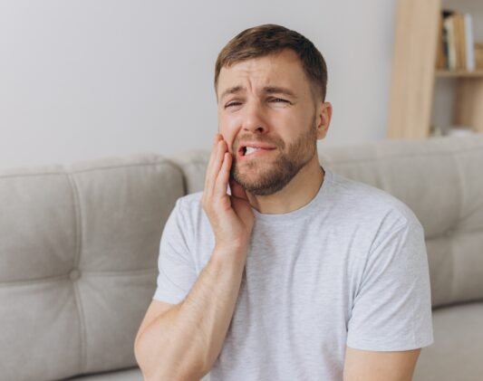 Dental health problems concept. Man suffering from strong toothache. Dental health problems concept. Man suffering from strong toothache.